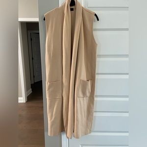 Brand New! Never worn. Size large. Sleeveless, long sweater.